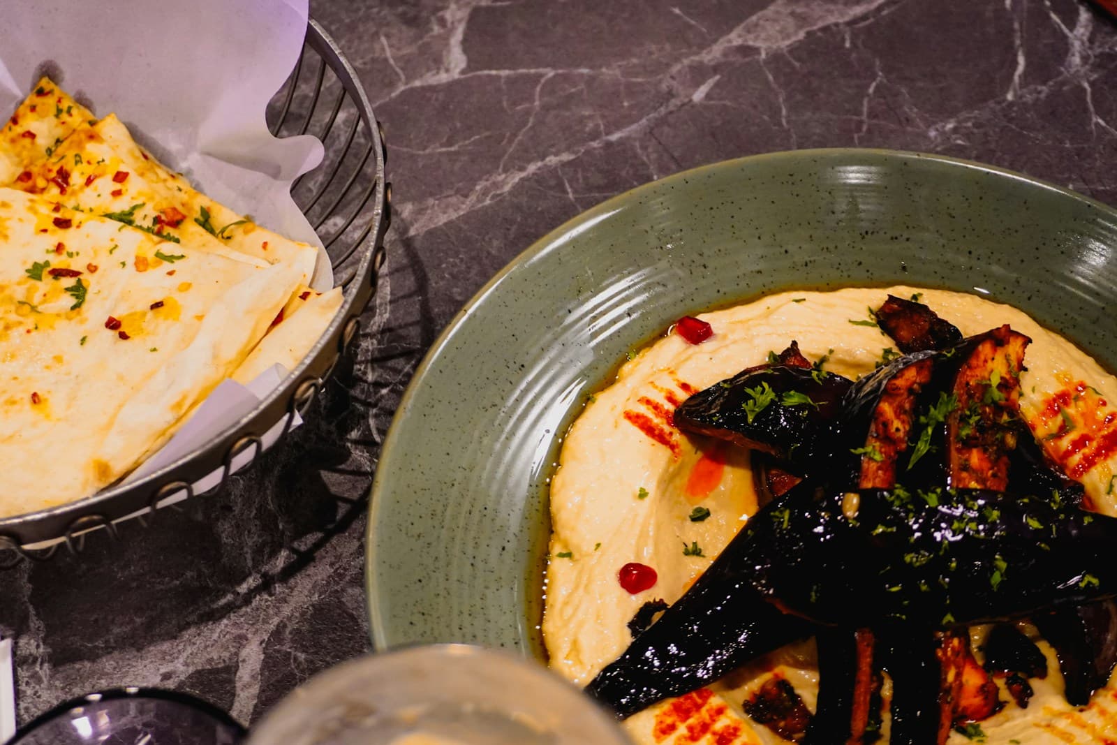 Roasted eggplant served with hummus and pita bread