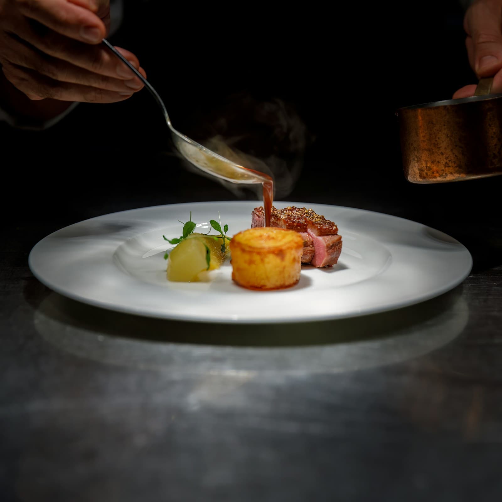 Chef finishing a restaurant dish