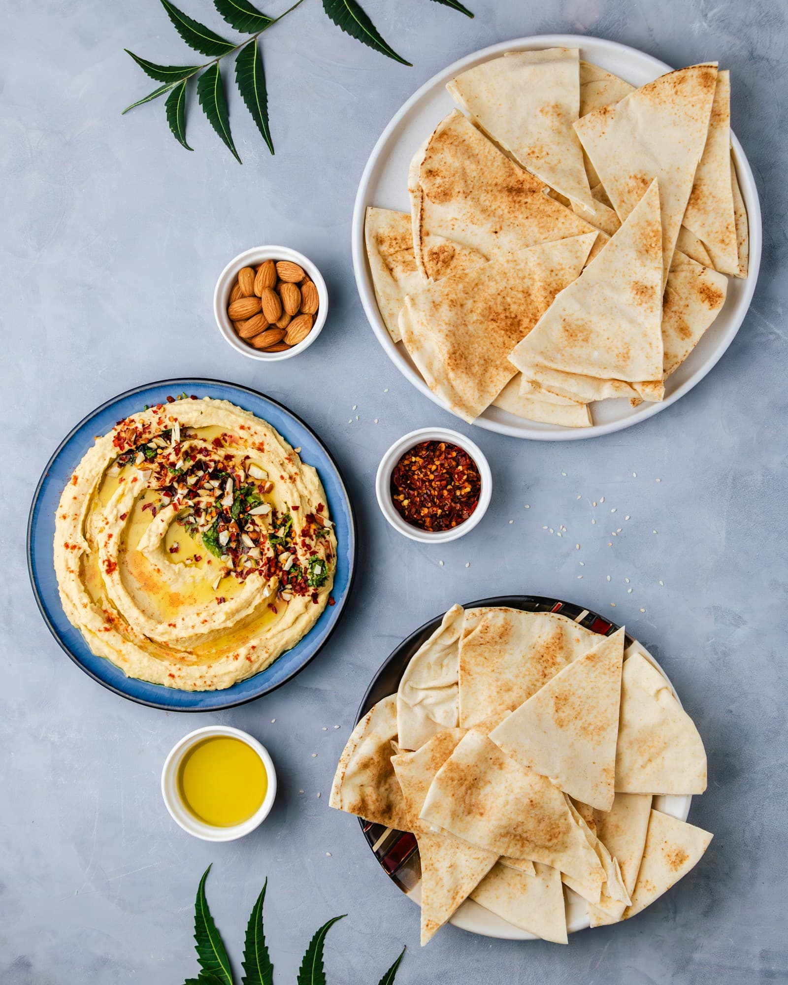 Creamy hummus and warm pita arranged on a plate
